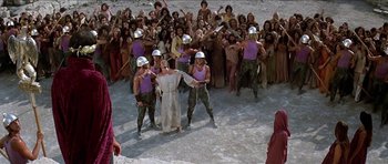 Movie still from “Jesus Christ Superstar” (1973), directed by Norman Jewison – A group of people dressed in military clothing and wearing helmets; Wide shot, High angle