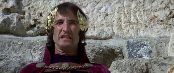 Movie still from “Jesus Christ Superstar” (1973), directed by Norman Jewison – A man wearing a gold crown and a purple robe; Close Up shot, Low angle