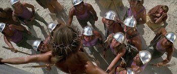 Movie still from “Jesus Christ Superstar” (1973), directed by Norman Jewison – A group of people wearing metal helmets and a crown of thorns on their head; Close Up shot, High angle