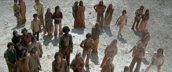 Movie still from “Jesus Christ Superstar” (1973), directed by Norman Jewison – A group of people standing in the dirt; Wide shot, High angle