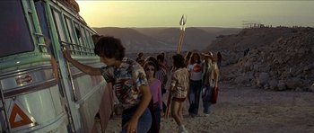 Movie still from “Jesus Christ Superstar” (1973), directed by Norman Jewison – A group of people walking down a dirt road; Wide shot, High angle