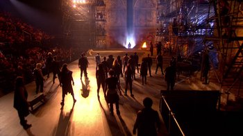 Movie still from “Jesus Christ Superstar Live in Concert” (2018), directed by Alex Rudzinski – A large group of people are dancing in a stage; Extreme Wide shot, High angle