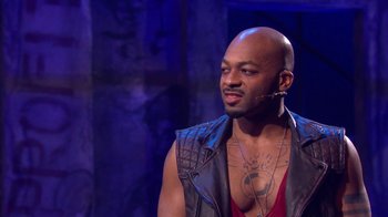 Movie still from “Jesus Christ Superstar Live in Concert” (2018), directed by Alex Rudzinski – A man with a beard is wearing a leather vest; Close Up shot, Over the shoulder angle