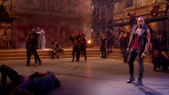 Movie still from “Jesus Christ Superstar Live in Concert” (2018), directed by Alex Rudzinski – A group of people standing around in a room; Wide shot, Over the shoulder angle