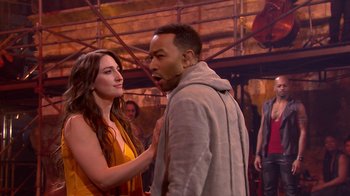 Movie still from “Jesus Christ Superstar Live in Concert” (2018), directed by Alex Rudzinski – A man and a woman standing next to each other in front of a crowd; Medium shot, Over the shoulder angle