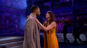 Movie still from “Jesus Christ Superstar Live in Concert” (2018), directed by Alex Rudzinski – A man and a woman standing next to each other; Medium shot, Over the shoulder angle