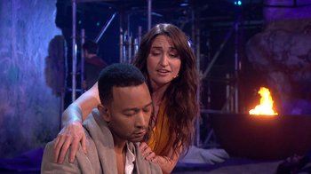 Movie still from “Jesus Christ Superstar Live in Concert” (2018), directed by Alex Rudzinski – A man and a woman are hugging on stage; Medium shot, Over the shoulder angle