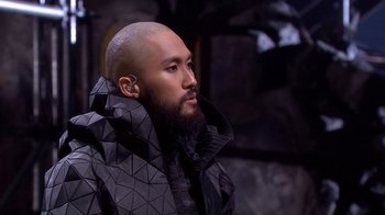 Movie still from “Jesus Christ Superstar Live in Concert” (2018), directed by Alex Rudzinski – A man with a beard wearing a black jacket; Close Up shot, High angle