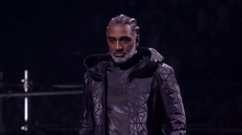 Movie still from “Jesus Christ Superstar Live in Concert” (2018), directed by Alex Rudzinski – A man in a black jacket and a beard; Close Up shot, Low angle