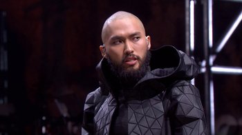 Movie still from “Jesus Christ Superstar Live in Concert” (2018), directed by Alex Rudzinski – A man with a beard is wearing a black jacket; Close Up shot, Over the shoulder angle