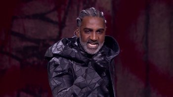 Movie still from “Jesus Christ Superstar Live in Concert” (2018), directed by Alex Rudzinski – A man in a black jacket with a white beard; Close Up shot, High angle