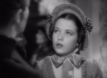 Movie still from “Jezebel” (1938), directed by William Wyler – A young woman in a hat and a dress; Close Up shot, High angle