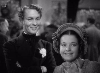 Movie still from “Jezebel” (1938), directed by William Wyler – A black and white photo of a man and a woman; Close Up shot, High angle