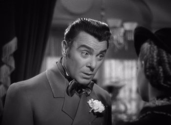 Movie still from “Jezebel” (1938), directed by William Wyler – A man in a suit and bow tie looking to his left; Close Up shot, Over the shoulder angle