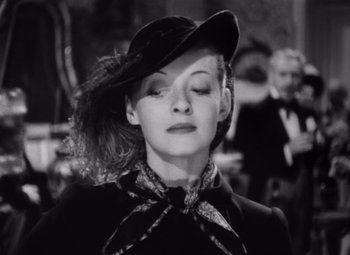 Movie still from “Jezebel” (1938), directed by William Wyler – A black and white photo of a woman wearing a hat; Close Up shot, Low angle