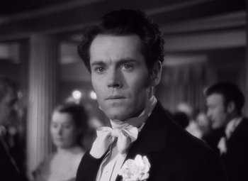 Movie still from “Jezebel” (1938), directed by William Wyler – Black and white photograph of a man in a tuxedo; Close Up shot, Low angle