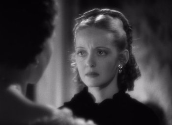 Movie still from “Jezebel” (1938), directed by William Wyler – A black - and - white photo of a woman looking at another woman; Close Up shot, Over the shoulder angle