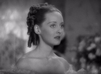 Movie still from “Jezebel” (1938), directed by William Wyler – A black - and - white photo of a woman in a dress; Close Up shot, High angle