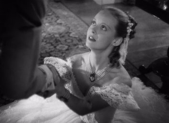 Movie still from “Jezebel” (1938), directed by William Wyler – A woman in a white dress holding a man's hand; Close Up shot, High angle