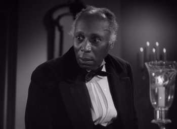 Movie still from “Jezebel” (1938), directed by William Wyler – An older man wearing a bow tie and a jacket; Close Up shot, High angle