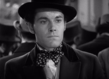 Movie still from “Jezebel” (1938), directed by William Wyler – A man wearing a top hat and a bow tie; Close Up shot, Low angle