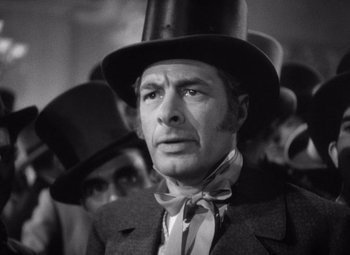 Movie still from “Jezebel” (1938), directed by William Wyler – A black and white photo of a man wearing a top hat; Close Up shot, Low angle
