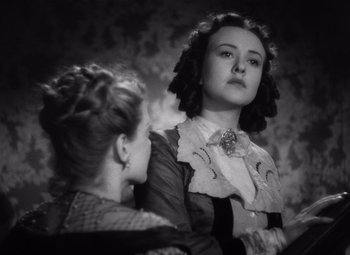 Movie still from “Jezebel” (1938), directed by William Wyler – Two women are looking at each other in a black and white photo; Close Up shot, Low angle