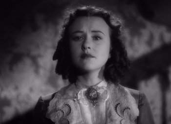 Movie still from “Jezebel” (1938), directed by William Wyler – A young woman wearing a white dress and a lace collar; Close Up shot, Low angle