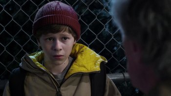 Movie still from “Turkey Hollow” (2015), directed by Kirk R. Thatcher – A young boy wearing a red hat and a yellow jacket; Close Up shot, Over the shoulder angle