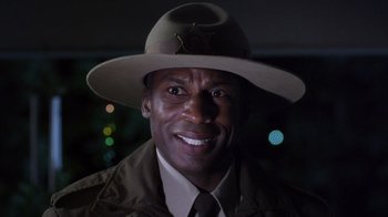 Movie still from “Turkey Hollow” (2015), directed by Kirk R. Thatcher – A man wearing a hat and a uniform; Close Up shot, Low angle