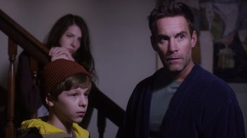 Movie still from “Turkey Hollow” (2015), directed by Kirk R. Thatcher – A man and a woman standing next to a young boy; Close Up shot, Over the shoulder angle