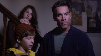Movie still from “Turkey Hollow” (2015), directed by Kirk R. Thatcher – A man and a woman standing next to a young boy; Close Up shot, Over the shoulder angle