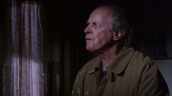 Movie still from “Turkey Hollow” (2015), directed by Kirk R. Thatcher – An older man in a brown jacket looking up; Close Up shot, Over the shoulder angle