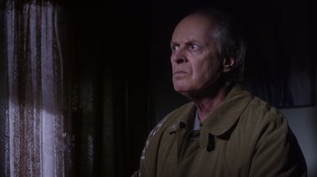 Movie still from “Turkey Hollow” (2015), directed by Kirk R. Thatcher – An older man in a tan jacket looking up; Close Up shot, Low angle