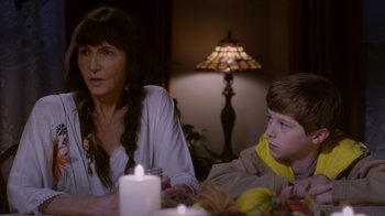 Movie still from “Turkey Hollow” (2015), directed by Kirk R. Thatcher – A woman sitting next to a child at a table; Close Up shot, Over the shoulder angle