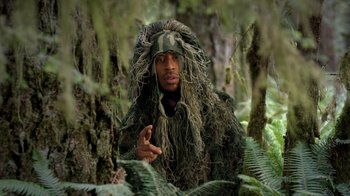 Movie still from “Turkey Hollow” (2015), directed by Kirk R. Thatcher – A man in a ghillie suit in the woods; Medium shot, Over the shoulder angle