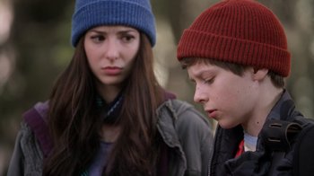 Movie still from “Turkey Hollow” (2015), directed by Kirk R. Thatcher – A young woman and a young boy wearing winter hats; Close Up shot, Over the shoulder angle
