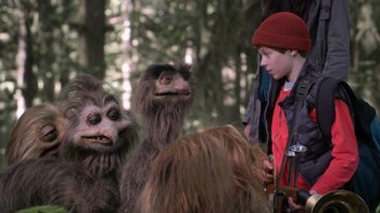 Movie still from “Turkey Hollow” (2015), directed by Kirk R. Thatcher – A group of people standing next to each other in the woods; Medium shot, Over the shoulder angle