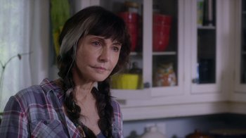 Movie still from “Turkey Hollow” (2015), directed by Kirk R. Thatcher – A woman in a plaid shirt with long braids; Close Up shot, Over the shoulder angle