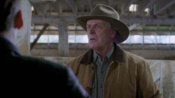 Movie still from “Turkey Hollow” (2015), directed by Kirk R. Thatcher – An older man wearing a hat and a jacket; Close Up shot, Over the shoulder angle