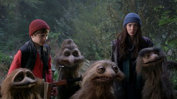 Movie still from “Turkey Hollow” (2015), directed by Kirk R. Thatcher – A woman and two boys are standing next to two furry creatures; Medium shot, Over the shoulder angle