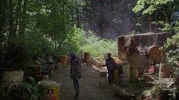 Movie still from “Turkey Hollow” (2015), directed by Kirk R. Thatcher – Two people standing on a dirt path near a forest; Extreme Wide shot, High angle
