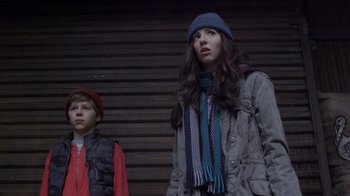 Movie still from “Turkey Hollow” (2015), directed by Kirk R. Thatcher – Two young people standing next to each other in front of a building; Medium shot, Low angle