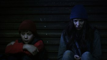 Movie still from “Turkey Hollow” (2015), directed by Kirk R. Thatcher – A woman and a boy sitting next to each other; Close Up shot, Low angle