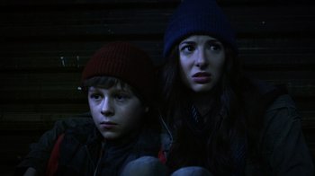 Movie still from “Turkey Hollow” (2015), directed by Kirk R. Thatcher – A couple of people sitting next to each other; Close Up shot, Low angle