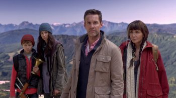 Movie still from “Turkey Hollow” (2015), directed by Kirk R. Thatcher – A man and two women standing in front of a mountain range; Medium shot, High angle