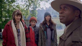 Movie still from “Turkey Hollow” (2015), directed by Kirk R. Thatcher – A group of people standing next to each other in a field; Medium shot, Over the shoulder angle