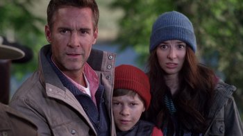 Movie still from “Turkey Hollow” (2015), directed by Kirk R. Thatcher – A man and a woman and a boy are standing together; Close Up shot, Over the shoulder angle