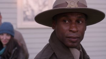 Movie still from “Turkey Hollow” (2015), directed by Kirk R. Thatcher – A man wearing a hat and a uniform; Close Up shot, Over the shoulder angle