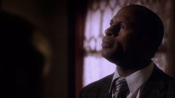 Movie still from “Turkey Hollow” (2015), directed by Kirk R. Thatcher – A person wearing a suit and a tie; Close Up shot, Low angle